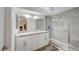 Stylish bathroom featuring dual sinks, modern lighting and a glass-enclosed shower at 2914 Luminous Ct, North Las Vegas, NV 89032