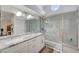 Modern bathroom featuring dual sinks, granite countertops, and a spacious glass-enclosed shower at 2914 Luminous Ct, North Las Vegas, NV 89032
