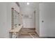 Clean hallway with modern flooring, a decorative console table and neutral color palette at 2914 Luminous Ct, North Las Vegas, NV 89032