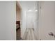 Hallway featuring modern flooring connecting to bedroom, laundry room, and other living spaces at 2914 Luminous Ct, North Las Vegas, NV 89032
