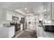 Modern kitchen design with ample lighting, granite countertops, and stainless steel appliances at 2914 Luminous Ct, North Las Vegas, NV 89032