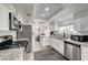 Well-lit kitchen features stainless steel appliances, granite countertops, and wood flooring at 2914 Luminous Ct, North Las Vegas, NV 89032
