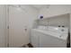 Functional laundry room with washer, dryer, and storage shelf at 2914 Luminous Ct, North Las Vegas, NV 89032
