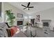 Well-lit living room with a charming fireplace, vaulted ceiling, ceiling fan and comfortable sofa at 2914 Luminous Ct, North Las Vegas, NV 89032