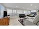 Spacious living area with many windows, modern furnishings, and bright neutral tones at 2914 Luminous Ct, North Las Vegas, NV 89032