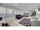 Bright open living area with large windows, tile floors, and comfortable furniture at 2914 Luminous Ct, North Las Vegas, NV 89032