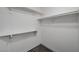 A well-lit walk-in closet features simple shelving and neutral carpet, maximizing storage space at 2914 Luminous Ct, North Las Vegas, NV 89032