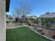 This backyard features a well-maintained lawn and desert landscaping for relaxed outdoor living at 3609 Citrus Heights Ave, North Las Vegas, NV 89081