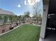 This backyard features a well-maintained lawn and desert landscaping for relaxed outdoor living at 3609 Citrus Heights Ave, North Las Vegas, NV 89081