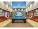 Spacious game room with a billiards table, seating, and elegant decor for entertaining guests at 3609 Citrus Heights Ave, North Las Vegas, NV 89081