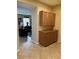 Hallway with neutral colored cabinets and tile flooring that leads to the living room at 3609 Citrus Heights Ave, North Las Vegas, NV 89081