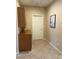 Hallway area with storage cabinet, showing tile flooring, door and accent wall hanging at 3609 Citrus Heights Ave, North Las Vegas, NV 89081