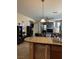 Modern kitchen with granite countertops and stainless steel appliances overlooking the living area at 3609 Citrus Heights Ave, North Las Vegas, NV 89081