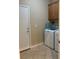 Well-equipped laundry room featuring modern appliances and tile flooring at 3609 Citrus Heights Ave, North Las Vegas, NV 89081