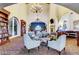 Elegant lobby with bookshelves, comfortable seating, a fireplace, and arched doorways and large chandeliers at 3609 Citrus Heights Ave, North Las Vegas, NV 89081