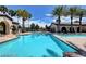 Inviting swimming pool surrounded by palm trees and lounge area, perfect for relaxation and recreation at 3609 Citrus Heights Ave, North Las Vegas, NV 89081