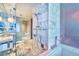 Modern bathroom featuring marble tile, glass shower, and elegant fixtures at 4381 W Flamingo Rd # 1019, Las Vegas, NV 89103