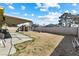 View of covered patio, storage shed and perimeter wall enclosing the yard at 4431 Bennett Dr, Las Vegas, NV 89121