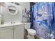 Cozy bathroom featuring a white vanity and sink, a toilet, and a shower with dolphin themed curtain at 4431 Bennett Dr, Las Vegas, NV 89121