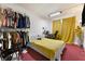 Simple bedroom with closet rod, desk, bed, and charming sunflower decor at 4431 Bennett Dr, Las Vegas, NV 89121