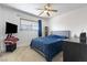 Comfortable bedroom featuring plush carpeting, a ceiling fan, and a calming blue comforter on the bed at 4431 Bennett Dr, Las Vegas, NV 89121
