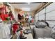 Cluttered garage featuring sofa, various decorations, and storage solutions at 4431 Bennett Dr, Las Vegas, NV 89121