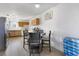 A kitchen with dining table set with seating for four, wood cabinets, and stainless steel refrigerator at 4431 Bennett Dr, Las Vegas, NV 89121