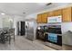 Open kitchen featuring laminate flooring, stainless appliances, and shaker cabinets at 4431 Bennett Dr, Las Vegas, NV 89121