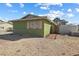 Shows side of the property with a small fence and some landscaping at 4431 Bennett Dr, Las Vegas, NV 89121