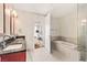 Modern bathroom with double vanity, separate soaking tub, and glass-enclosed shower at 4575 Dean Martin Dr # 1811, Las Vegas, NV 89103