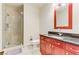 Bright bathroom featuring a glass-enclosed shower, red vanity with drawers, and a large framed mirror at 4575 Dean Martin Dr # 1811, Las Vegas, NV 89103