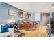 Open-concept living room with a modern kitchen, bar seating, and a stylish blue accent wall at 4575 Dean Martin Dr # 1811, Las Vegas, NV 89103
