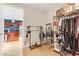 Large walk-in closet with metal clothing racks, purse shelves, and wood-look flooring open to kitchen at 4575 Dean Martin Dr # 1811, Las Vegas, NV 89103