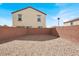 View of home from the spacious backyard enclosed with brick wall and rock landscaping at 4941 Quest Tribe St, Las Vegas, NV 89122