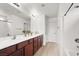 Bathroom showcasing a wide mirror over double sinks and a shower and bathtub at 4941 Quest Tribe St, Las Vegas, NV 89122