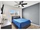 This bedroom offers a ceiling fan, a TV and dresser at 4941 Quest Tribe St, Las Vegas, NV 89122