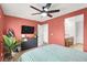 This bedroom offers a ceiling fan, TV, and access to an ensuite bathroom at 4941 Quest Tribe St, Las Vegas, NV 89122