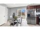 Bright dining area and kitchen with stainless refrigerator and sliding door to the backyard at 4941 Quest Tribe St, Las Vegas, NV 89122