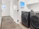 Well-lit laundry room featuring a new washer and dryer at 4941 Quest Tribe St, Las Vegas, NV 89122