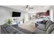 Spacious living room featuring a modern sofa, and an open floor plan at 4941 Quest Tribe St, Las Vegas, NV 89122