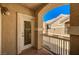 View from the balcony featuring a white door, brown railings, and partial view of the building across the street at 5855 Valley Dr # 2108, North Las Vegas, NV 89031