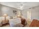 Comfortable bedroom with a patterned bedspread, two end tables and a doorway to the en-suite bathroom at 5855 Valley Dr # 2108, North Las Vegas, NV 89031