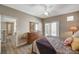 Bright bedroom featuring a ceiling fan, wood dresser and access to a private balcony with natural light at 5855 Valley Dr # 2108, North Las Vegas, NV 89031