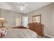 Bedroom featuring a wood dresser, ceiling fan and a view into the attached bathroom with shower at 5855 Valley Dr # 2108, North Las Vegas, NV 89031