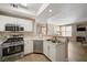 Modern kitchen with stainless steel appliances open to a spacious living area at 5855 Valley Dr # 2108, North Las Vegas, NV 89031
