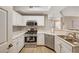 Bright kitchen featuring white cabinets and stainless steel appliances at 5855 Valley Dr # 2108, North Las Vegas, NV 89031