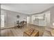 Open concept living room and dining area with modern wood floors and seamless flow to the kitchen at 5855 Valley Dr # 2108, North Las Vegas, NV 89031