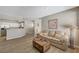 Living room featuring wood floors, neutral tones, a comfortable sofa, and an open floor plan at 5855 Valley Dr # 2108, North Las Vegas, NV 89031
