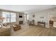 Cozy living room featuring wood floors, a fireplace, and a dining area with natural light at 5855 Valley Dr # 2108, North Las Vegas, NV 89031
