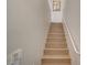 A bright staircase with light wood steps and white handrail ascends to the upper level of the home at 5855 Valley Dr # 2108, North Las Vegas, NV 89031